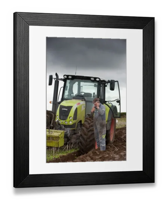 Framed Print : Farmer talking on mobile phone, standing beside stationary tractor during ploughing, Scotland, september Framed Print : Farmer talking on mobile phone, standing beside stationary tractor during ploughing, Scotland, september