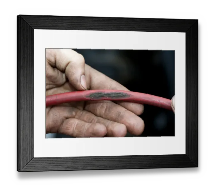 Framed Print : Mechanic with worn cable on tractor which could be dangerous, England, october