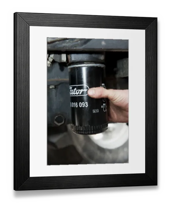 Framed Print : Removing oil filter from tractor engine block, England, october Framed Print : Removing oil filter from tractor engine block, England, october