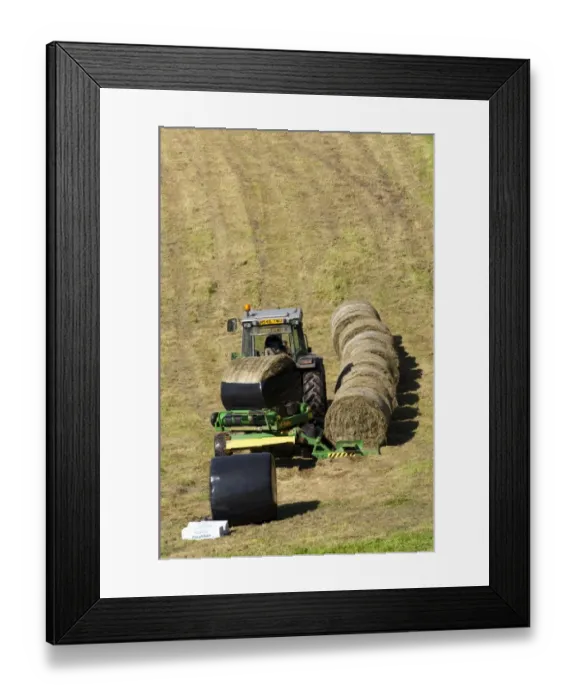 Framed Print : Plastic being wrapped around silage bale, wrapped by mechanical bale-wrapper in meadow, Yorkshire Dales, Yorkshire Framed Print : Plastic being wrapped around silage bale, wrapped by mechanical bale-wrapper in meadow, Yorkshire Dales, Yorkshire