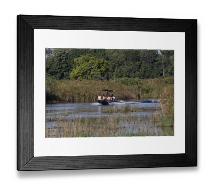 Framed Print : Tourists explore the Monachena River by speed boat. Okavango Delta, Botswana