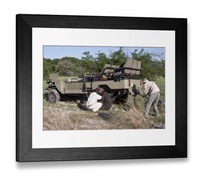 Framed Print : Fixing a flat tyre in the African bush Uri 4 wheel drive