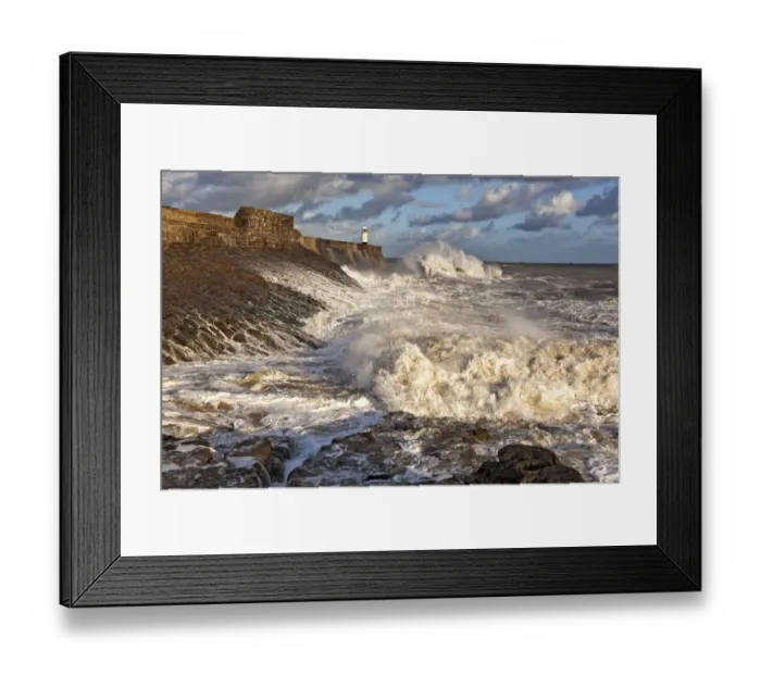 Framed Print : Coastal resort town seafront and lighthouse bombarded by waves, Porthcawl Pier, Porthcawl, Bristol Channel