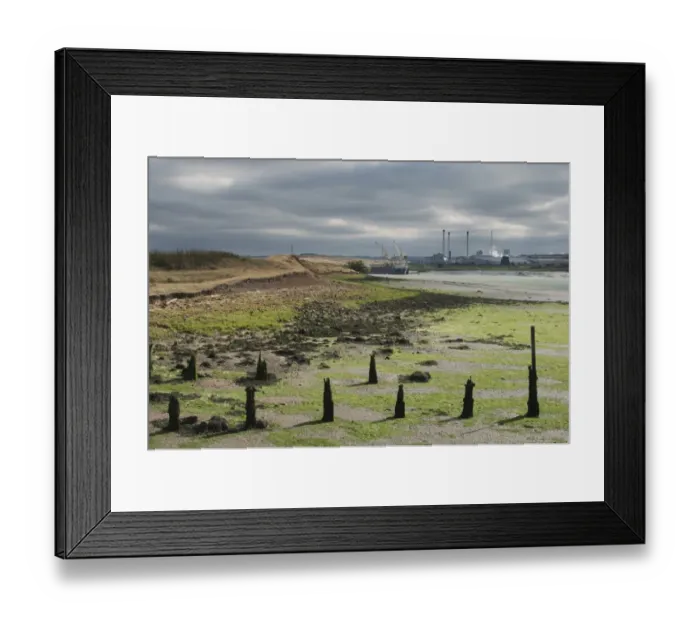 Framed Print : Estuary at low tide revealing mudflats and breakwaters, with paper mill in distance, Swale Estuary, Isle of Sheppey Framed Print : Estuary at low tide revealing mudflats and breakwaters, with paper mill in distance, Swale Estuary, Isle of Sheppey