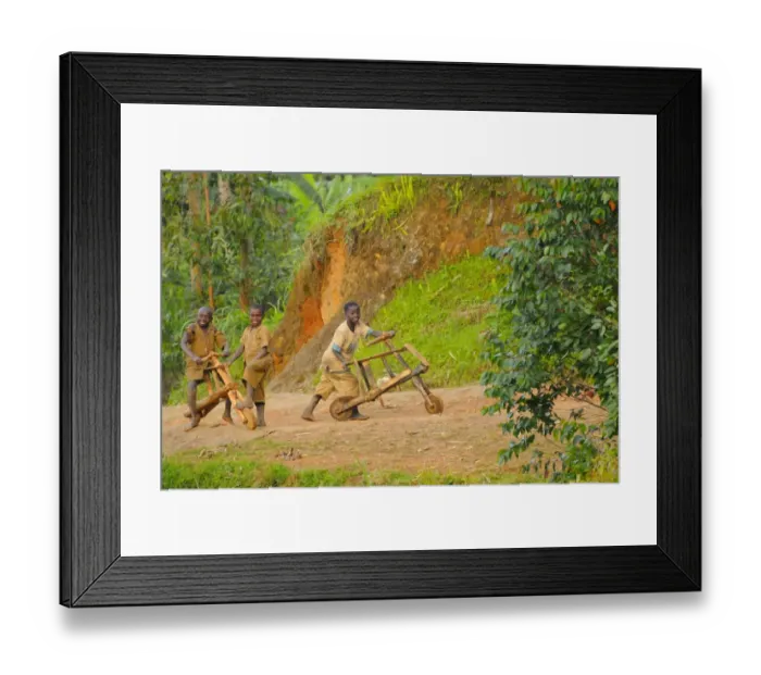 Framed Print : Children playing with wood-made bicycles on track at edge of Nyungwe Forest N. P. Rwanda, march Framed Print : Children playing with wood-made bicycles on track at edge of Nyungwe Forest N. P. Rwanda, march