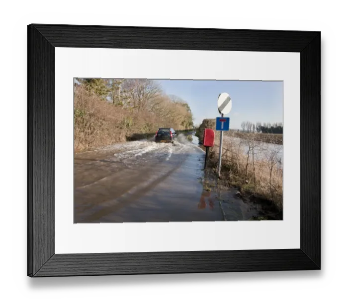 Framed Print : Flooded rural road with vehicle driving through, West Sussex, England, january