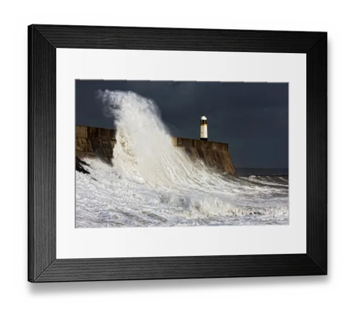 Framed Print : Coastal resort town seafront and lighthouse bombarded by waves during storm, Porthcawl Pier, Porthcawl
