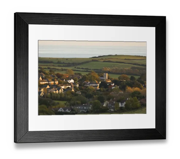 Framed Print : View of village, church, farmland and sea in distance, Preston, Dorset, England, october Framed Print : View of village, church, farmland and sea in distance, Preston, Dorset, England, october