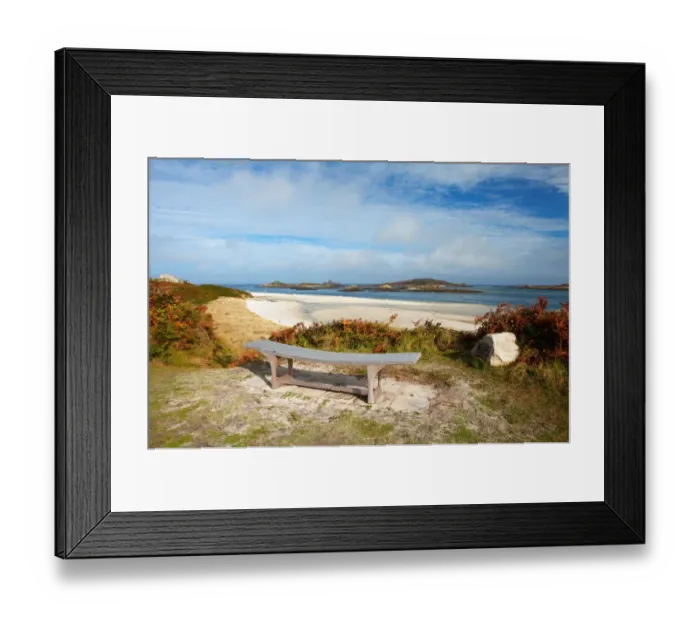 Framed Print : View of bench, sandy beach and coastline, looking towards Foremans Island, Northwethel and Round Island on horizon Framed Print : View of bench, sandy beach and coastline, looking towards Foremans Island, Northwethel and Round Island on horizon