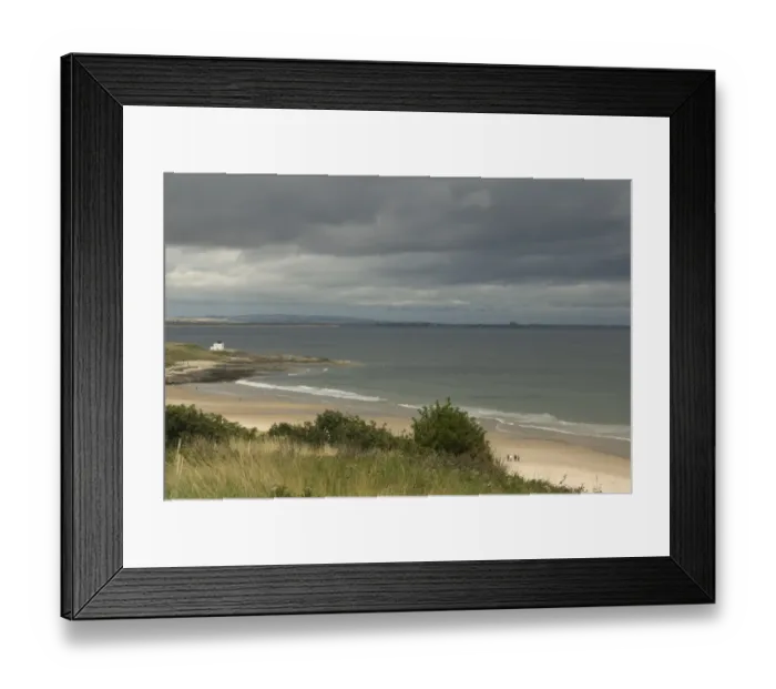 Framed Print : View of beach and coastline with stormy sky, Bamburgh, Northumberland, England, august Framed Print : View of beach and coastline with stormy sky, Bamburgh, Northumberland, England, august