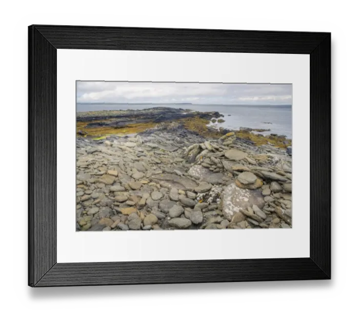 Framed Print : View of pebbles on rocky beach, with island of Shapinsay in distance, Rerwick Head, Mainland, Orkney, Scotland, june Framed Print : View of pebbles on rocky beach, with island of Shapinsay in distance, Rerwick Head, Mainland, Orkney, Scotland, june