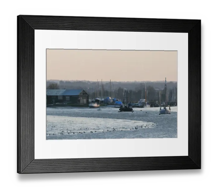 Framed Print : View of coastal creek with boats and feeding waders at sunset, Oare Creek, Oare, Faversham, North Kent, England
