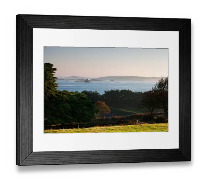 Framed Print : View of coastline with lifting sea mist at at sunrise, St. Martins visible in distance, Borough Farm, Tresco Framed Print : View of coastline with lifting sea mist at at sunrise, St. Martins visible in distance, Borough Farm, Tresco