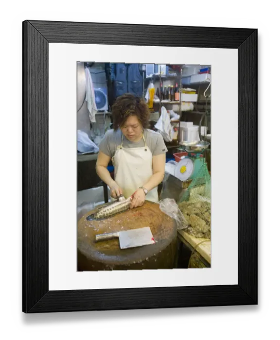 Framed Print : Woman preparing fish beside frogs in net at fish market, Kowloon, Hong Kong, China Framed Print : Woman preparing fish beside frogs in net at fish market, Kowloon, Hong Kong, China