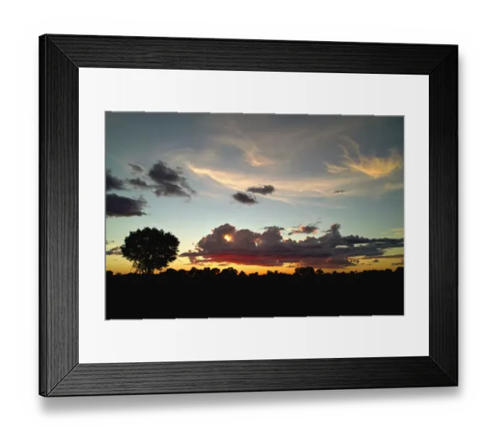 Framed Print : Evening sky in the Okavango Delta, the sun sets behind cumulus clouds with some cirrus clouds high in the sky Framed Print : Evening sky in the Okavango Delta, the sun sets behind cumulus clouds with some cirrus clouds high in the sky