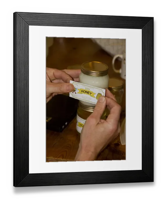 Framed Print : Labelling up a pot of Borage Honey, this has a white colour