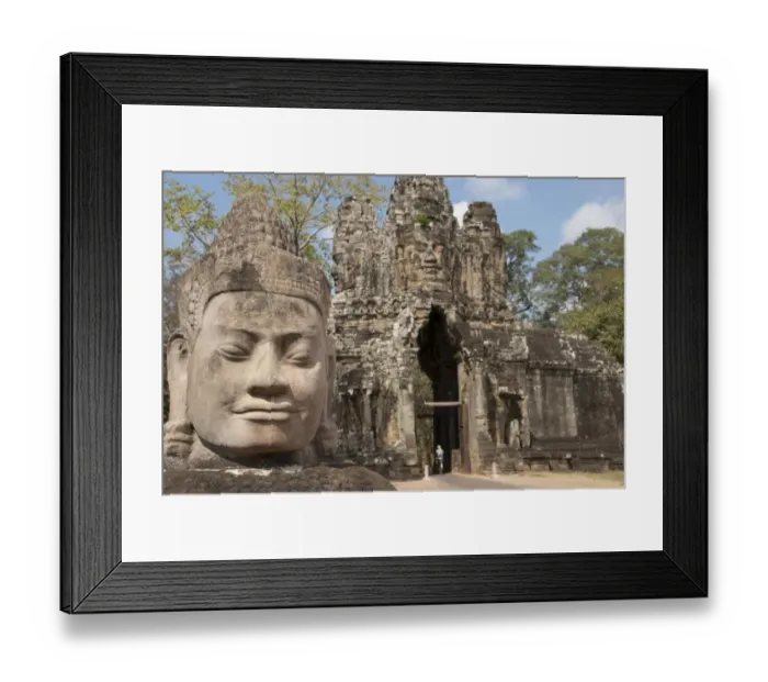 Framed Print : Sculpture of head beside road to gate tower of Khmer temple, South Gate, Angkor Thom, Siem Riep, Cambodia