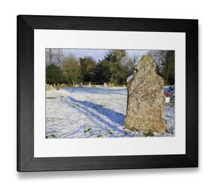 Framed Print : Headstones in snow covered church graveyard, St. Marys Church, Bacton, Suffolk, England, november