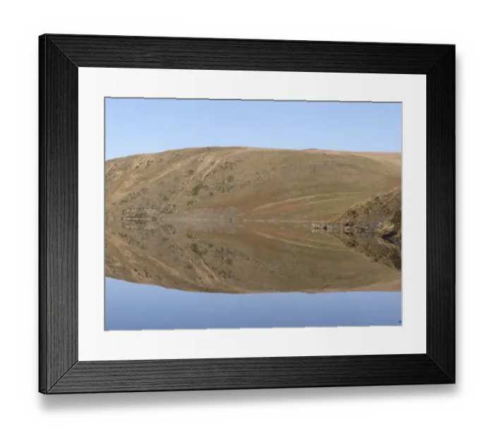 Framed Print : Banks of reservoir reflected in water, Claerwen Dam, Elan Valley, Powys, Wales, january