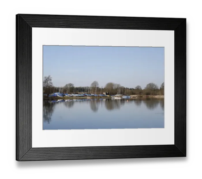 Framed Print : View of sailing boats at edge of flooded former gravel pit habitat, Sailing Lake, Lackford Lakes Nature Reserve Framed Print : View of sailing boats at edge of flooded former gravel pit habitat, Sailing Lake, Lackford Lakes Nature Reserve