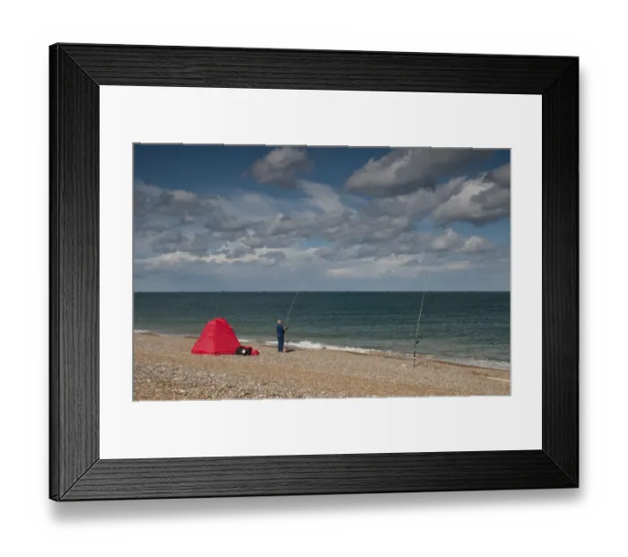 Framed Print : Sea angler fishing beside shelter on shingle beach, Cley, Norfolk, England, september Framed Print : Sea angler fishing beside shelter on shingle beach, Cley, Norfolk, England, september