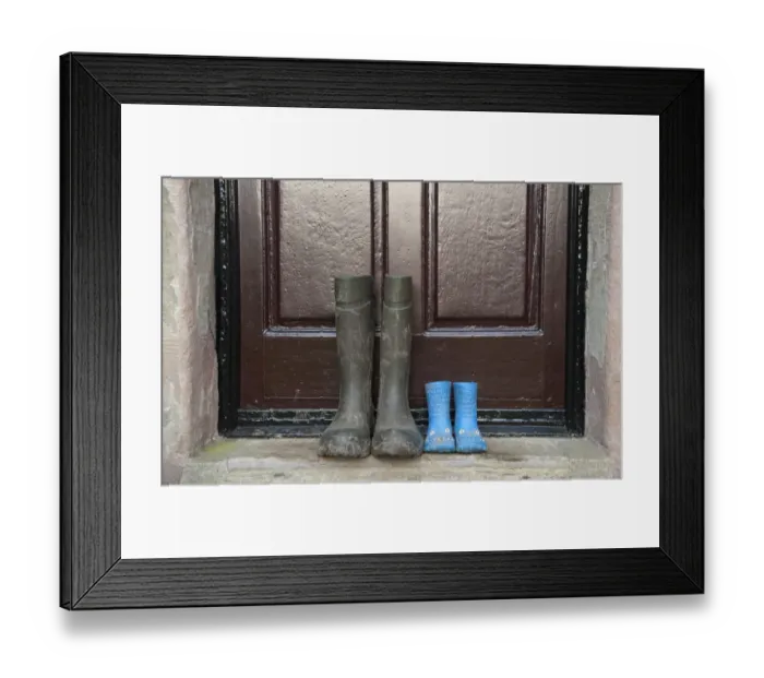 Framed Print : Two pairs of wellington boots, one childrens pair and one mens pair, outside farmhouse door, Whitewell, Lancashire