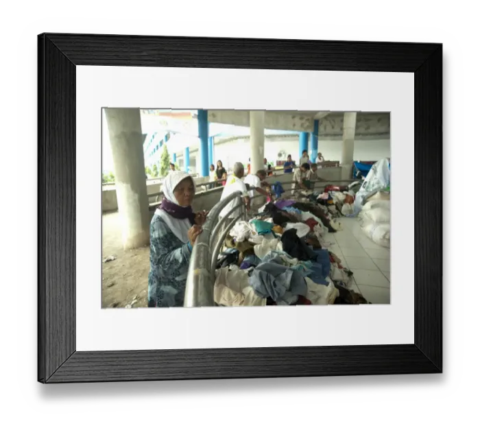 Framed Print : Old woman looking at clothes for refugees from recent volcanic eruption, Maguwo, Mount Merapi, Central Java, Indonesia Framed Print : Old woman looking at clothes for refugees from recent volcanic eruption, Maguwo, Mount Merapi, Central Java, Indonesia