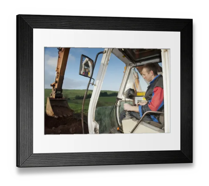 Framed Print : Excavator digging stone on hillside, England, november