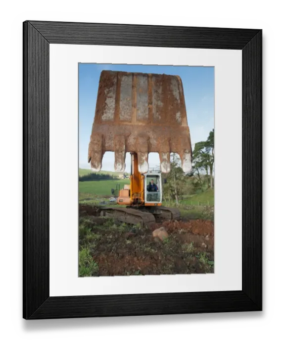 Framed Print : Excavator digging stone on hillside, England, november