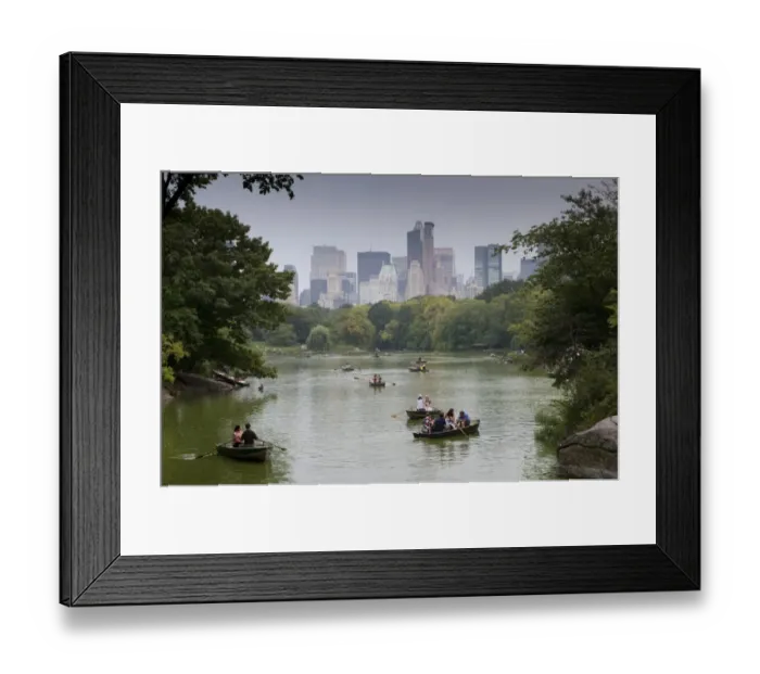 Framed Print : Tourists in rowing boats on boating lake in city parkland, with skyline of skyscrapers in background, Central Park Framed Print : Tourists in rowing boats on boating lake in city parkland, with skyline of skyscrapers in background, Central Park