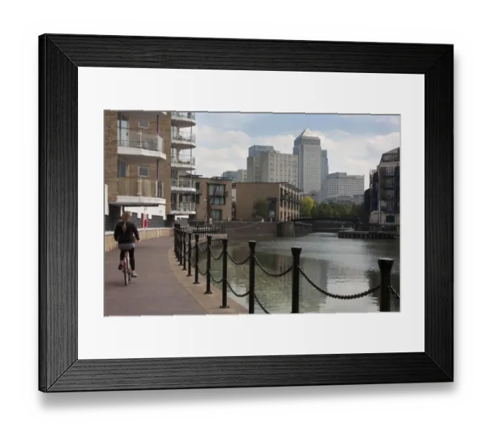 Framed Print : Woman cycling beside waterway with redevelopment, Canary Wharf in distance, Limehouse Basin, Limehouse, Tower Hamlets Framed Print : Woman cycling beside waterway with redevelopment, Canary Wharf in distance, Limehouse Basin, Limehouse, Tower Hamlets