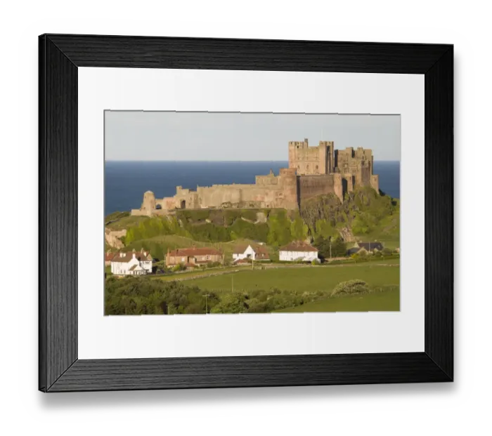 Framed Print : View fields and village towards castle, Bamburgh Castle, Northumberland, England, may Framed Print : View fields and village towards castle, Bamburgh Castle, Northumberland, England, may