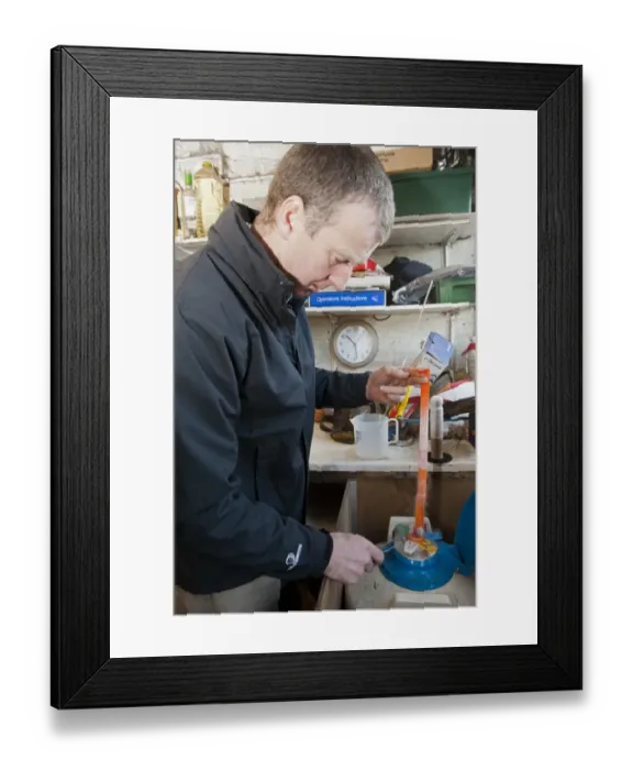 Framed Print : Cattle farming, farmer taking frozen bull semen from flask of liquid nitrogen, England, november