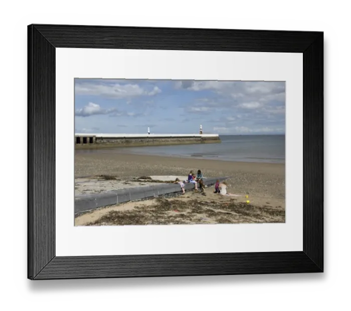 Framed Print : View of family on beach with jetty and lighthouse in background, Ramsey, Isle of Man, june Framed Print : View of family on beach with jetty and lighthouse in background, Ramsey, Isle of Man, june