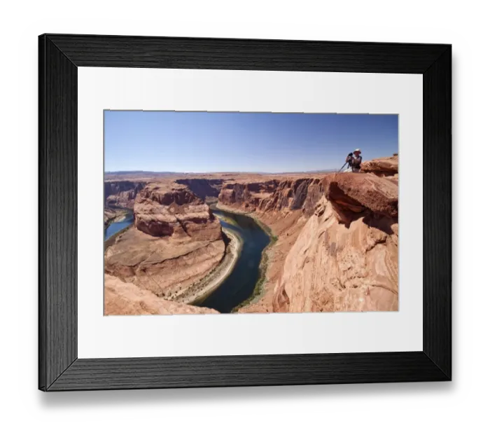Framed Print : Photogarpher at the Horseshoe bend overlook, the Colorado River in Glen Canyon is making a 270 curve in an entrenched Framed Print : Photogarpher at the Horseshoe bend overlook, the Colorado River in Glen Canyon is making a 270 curve in an entrenched