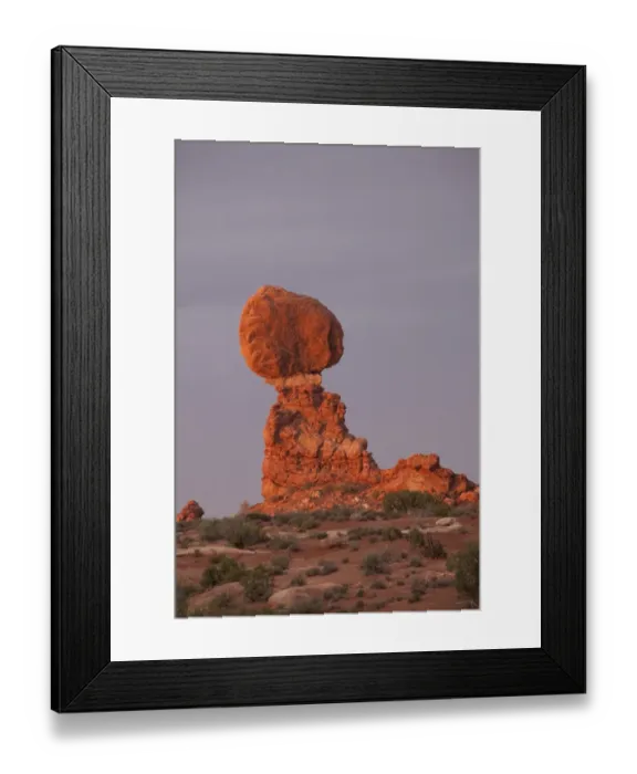 Framed Print : Balanced Rock in the glow of evening light is a defiant 55-foot tall block of Estrada Sandstone that rests on a narrow