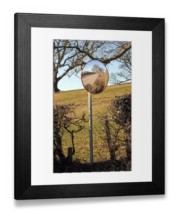 Framed Print : Use of convex mirror to see road traffic from farm entrance, North Wales, march Framed Print : Use of convex mirror to see road traffic from farm entrance, North Wales, march