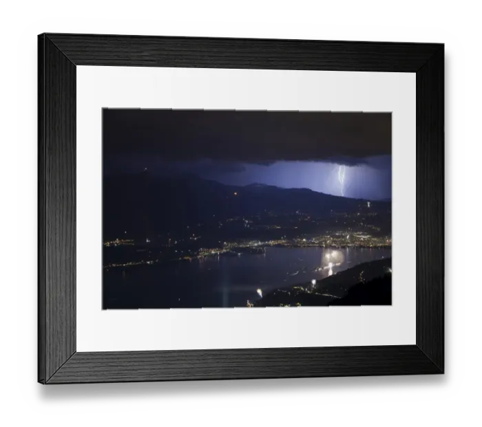 Framed Print : Thunderstorm with lightning and fireworks over city and lake at night, Thun, Lake Thun, Swiss Alps, Bernese Oberland Framed Print : Thunderstorm with lightning and fireworks over city and lake at night, Thun, Lake Thun, Swiss Alps, Bernese Oberland