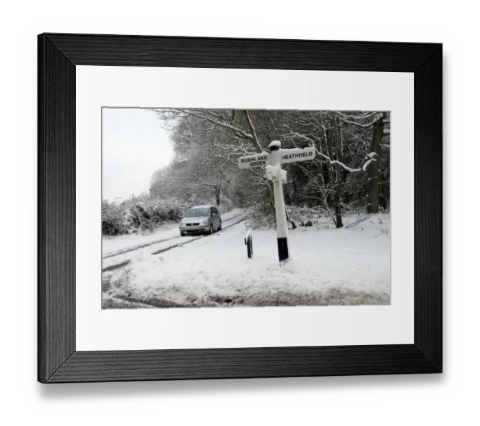 Framed Print : Wooden signpost and car in snow covered lane, near Heathfield, East Sussex, England, January Framed Print : Wooden signpost and car in snow covered lane, near Heathfield, East Sussex, England, January