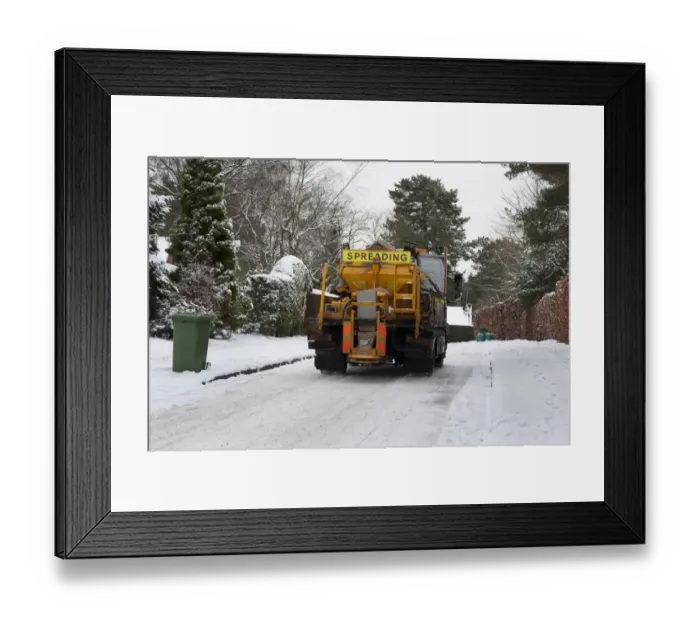 Framed Print : Council gritter lorry gritting snow covered residential road, Surrey, England, January