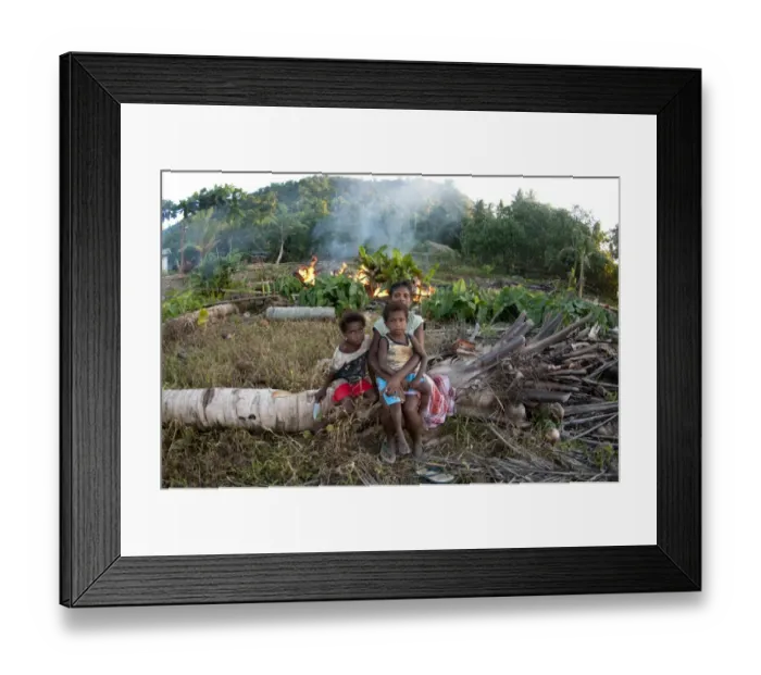 Framed Print : Family sitting on fallen tree near burning rubbish, Warmindi, Birds Head Peninsula, Raja Ampat Islands (Four Kings) Framed Print : Family sitting on fallen tree near burning rubbish, Warmindi, Birds Head Peninsula, Raja Ampat Islands (Four Kings)
