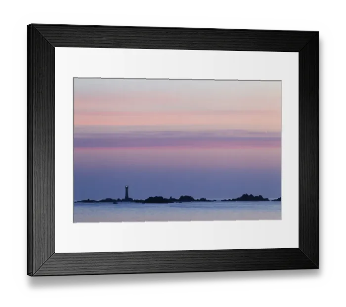 Framed Print : View of coastline with lighthouse at sunset, L Eree Bay, Guernsey, Channel Islands, May
