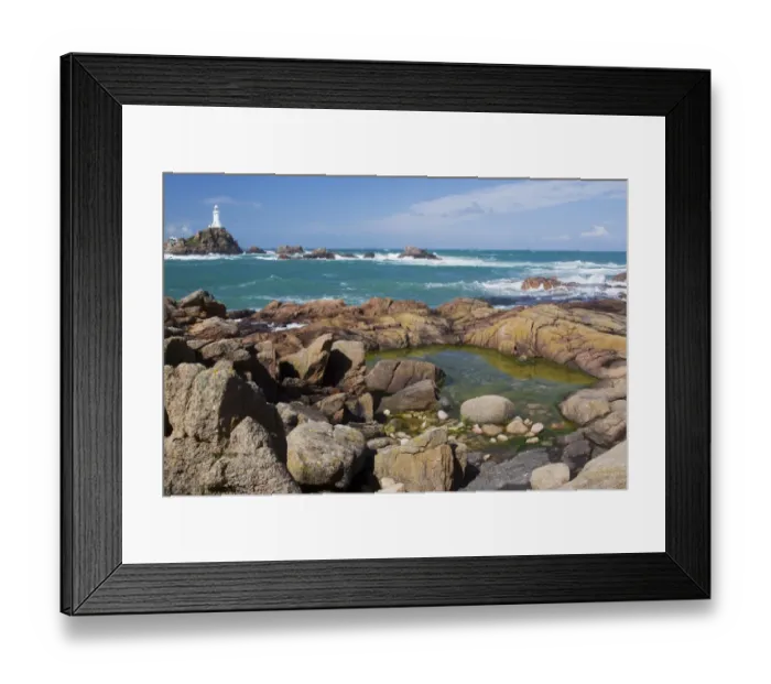 Framed Print : Rockpool on rocky shore at low tide, with lighthouse in background, La Corbiere Lighthouse, La Corbiere, St Framed Print : Rockpool on rocky shore at low tide, with lighthouse in background, La Corbiere Lighthouse, La Corbiere, St