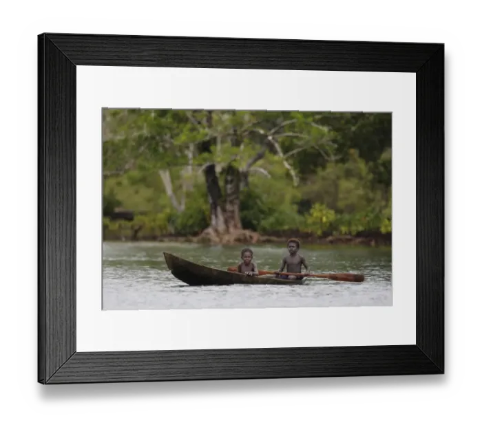 Framed Print : Two boys paddling dugout canoe, Kolombangara Island, Solomon Islands, April Framed Print : Two boys paddling dugout canoe, Kolombangara Island, Solomon Islands, April