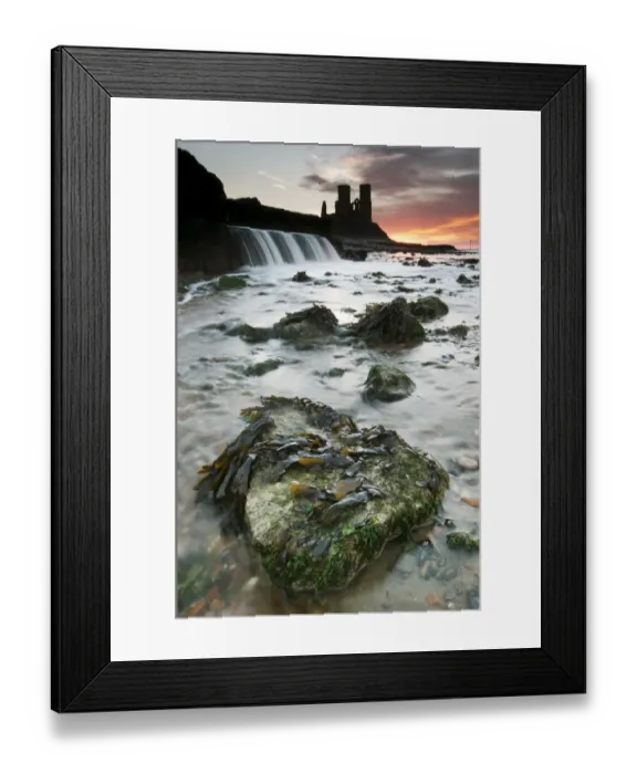Framed Print : View of beach and outflow, with 12th Century ruined church in distance, silhouetted at sunrise, St Framed Print : View of beach and outflow, with 12th Century ruined church in distance, silhouetted at sunrise, St