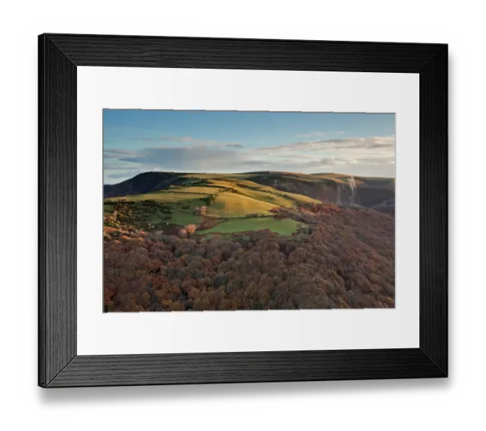 Framed Print : View of hill lit by early morning sunlight and mist rising from trees in woodland, on chilly autumn morning near coast Framed Print : View of hill lit by early morning sunlight and mist rising from trees in woodland, on chilly autumn morning near coast