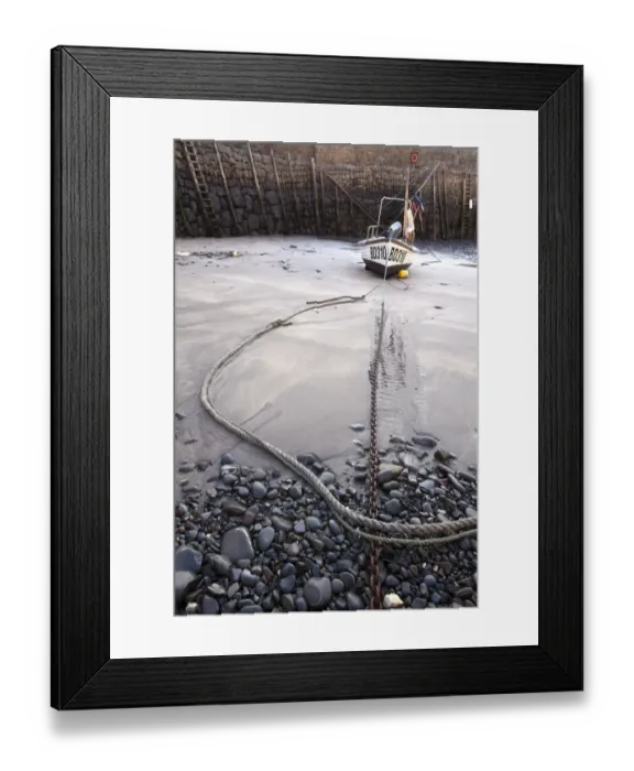 Framed Print : Small fishing boat on sand, moored in village harbour at low tide, Clovelly, Torridge, North Devon, England, May