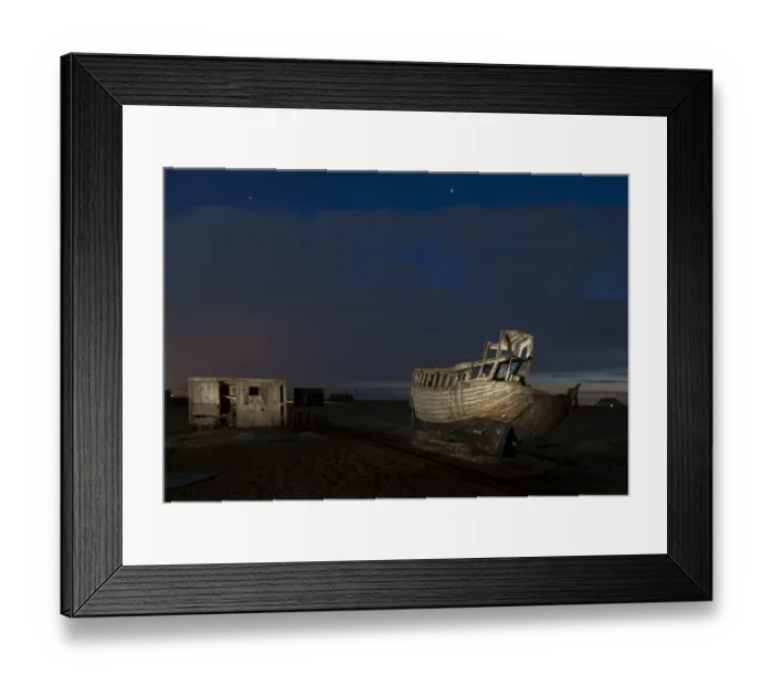 Framed Print : Abandoned fishing boat and fisherman hut on shingle beach at night, Dungeness, Kent, England, April