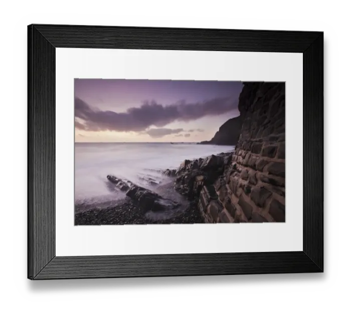 Framed Print : View of seawall, rocks on beach and cliff at sunset, Welcome Beach, North Devon, England, September Framed Print : View of seawall, rocks on beach and cliff at sunset, Welcome Beach, North Devon, England, September