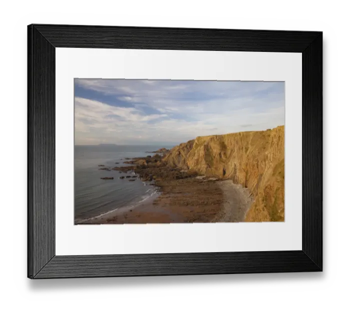 Framed Print : View of coastal cliff with folded strata in late afternoon sunlight, with Lundy Island on horizon in distance Framed Print : View of coastal cliff with folded strata in late afternoon sunlight, with Lundy Island on horizon in distance
